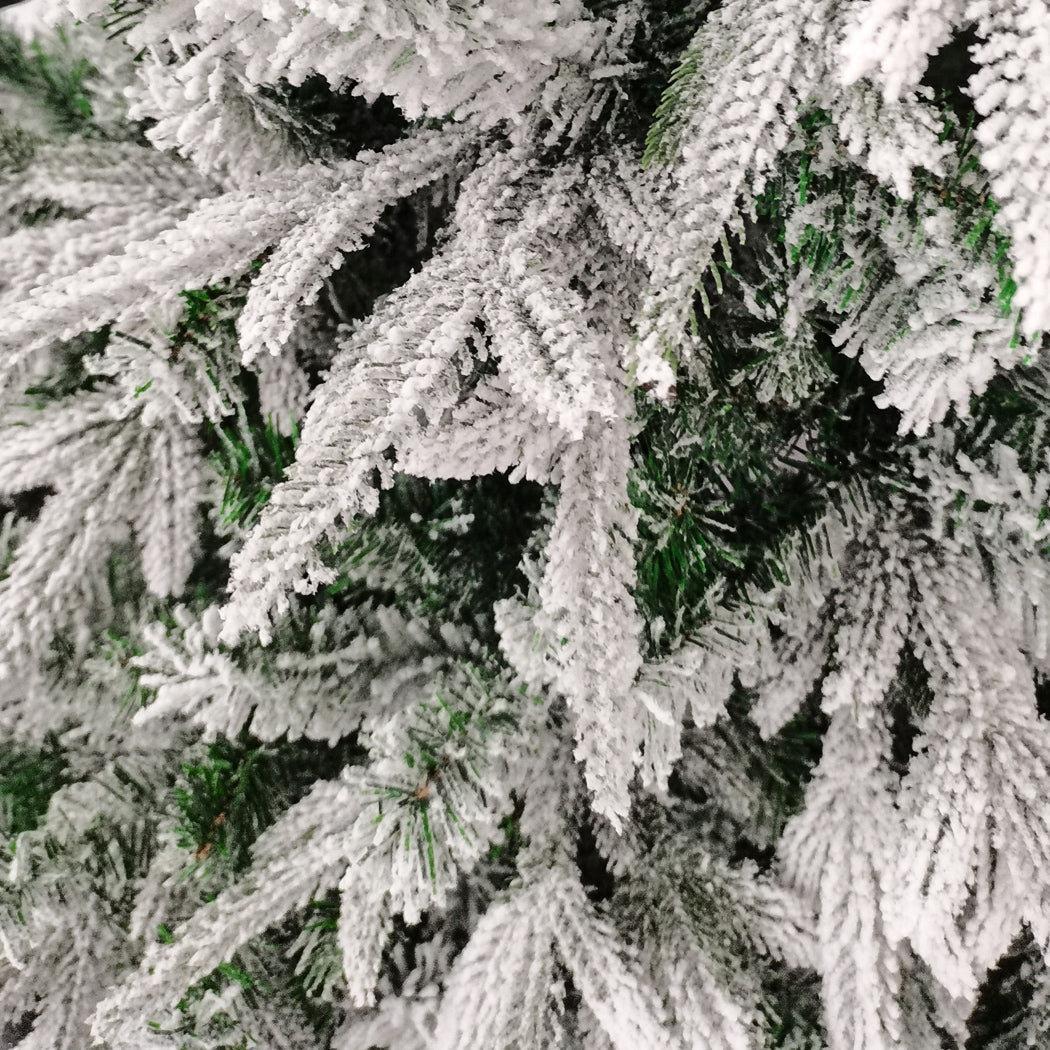 Santaco 1.5M snow flocked Christmas tree adorned with fairy lights and colorful ornaments, creating a festive holiday atmosphere.