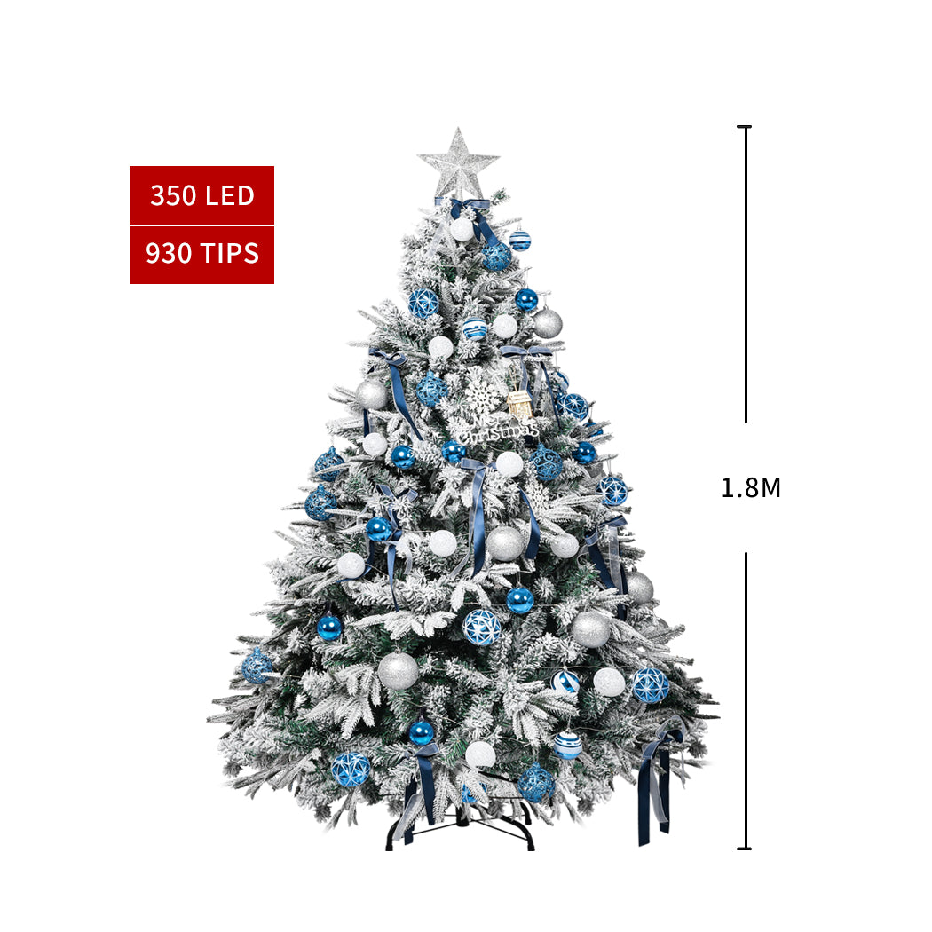 Santaco 1.8M snow flocked Christmas tree adorned with LED fairy lights and colorful ornaments, creating a festive holiday atmosphere.