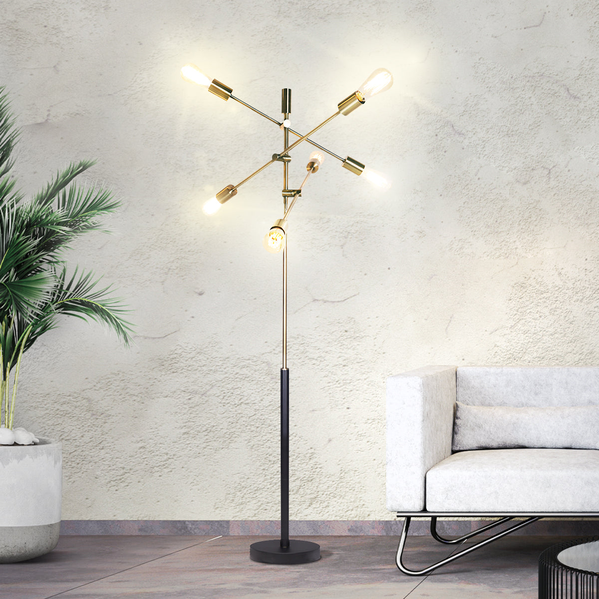 Sarantino 6-Light Metal Sputnik Floor Lamp with adjustable arms and antique brass finish, elegantly illuminating a modern living space.