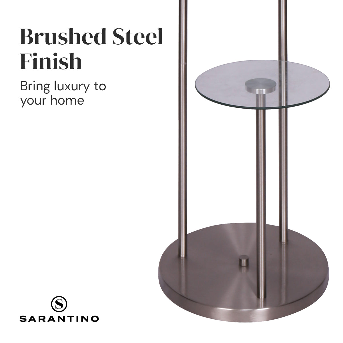 Sarantino Metal Floor Lamp featuring brushed steel finish, two glass shelves, and a textured white fabric drum shade, ideal for modern interiors.