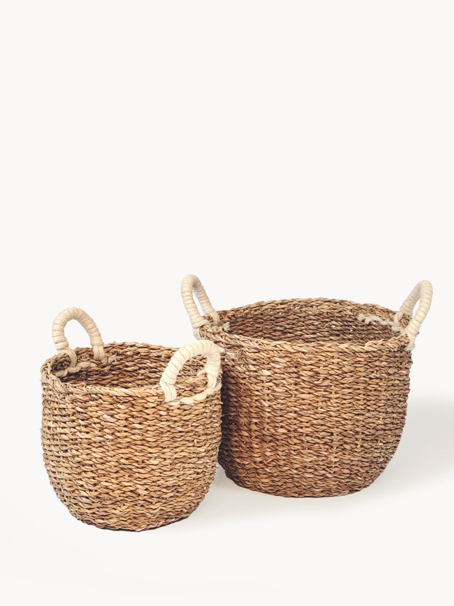 Savar Basket with White Handle made from natural seagrass, showcasing its elegant design and practical storage capabilities.