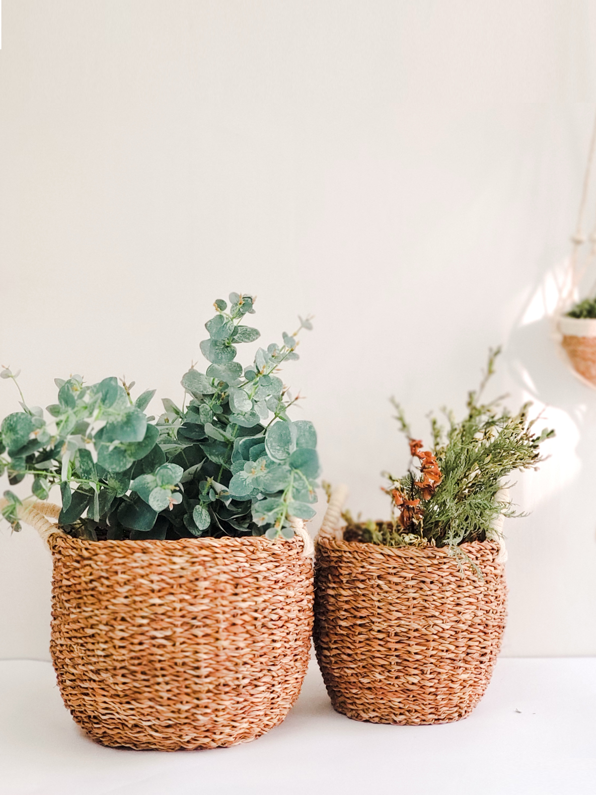 Savar Basket with White Handle made from natural seagrass, showcasing its elegant design and practical storage capabilities.