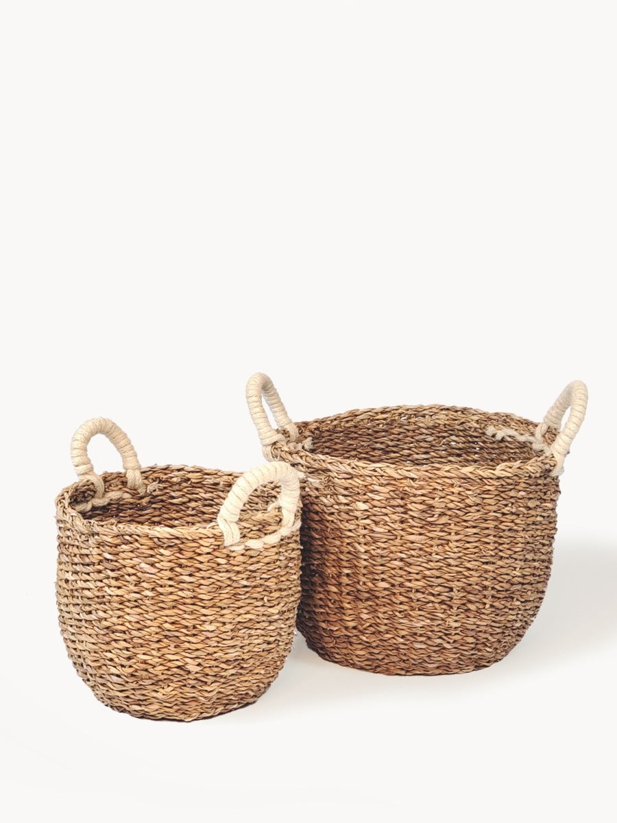 Savar Basket with White Handle made from natural seagrass, showcasing its elegant design and practical storage capabilities.