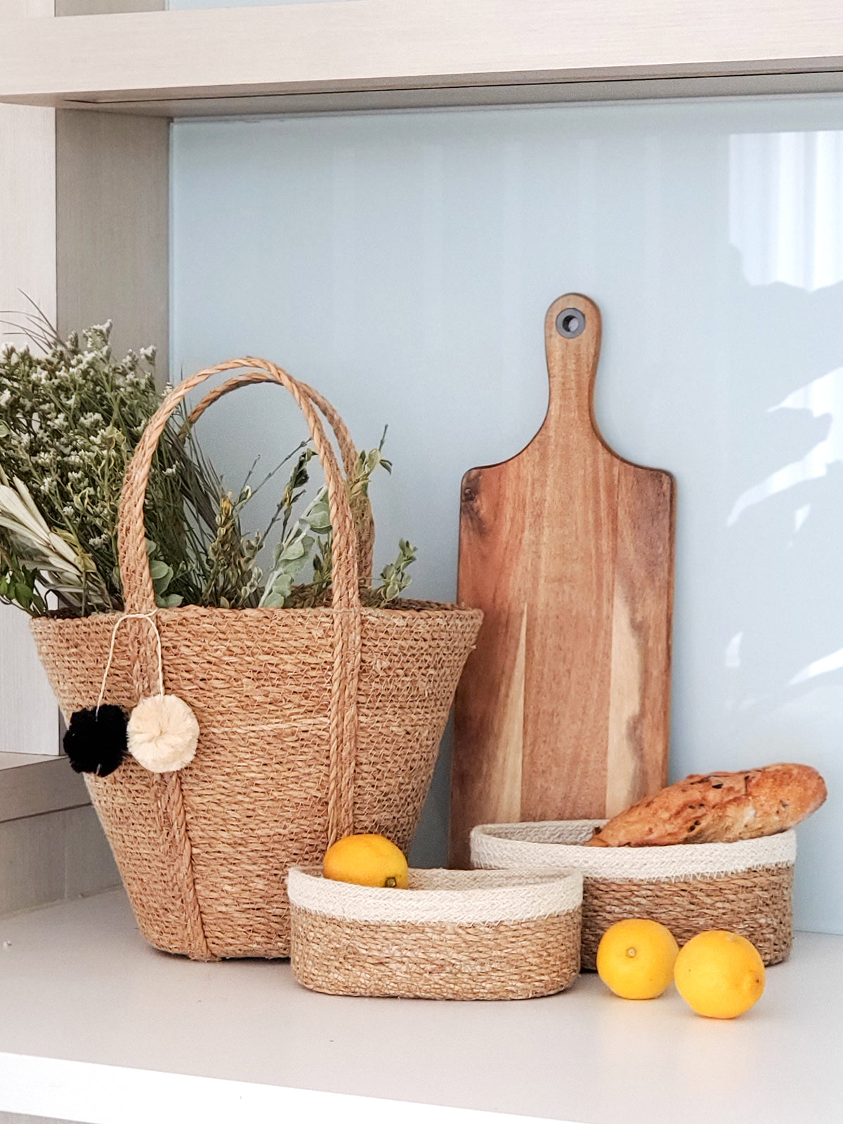 Set of 3 Savar Oval Bowls made from seagrass and jute, showcasing their natural and white colors.