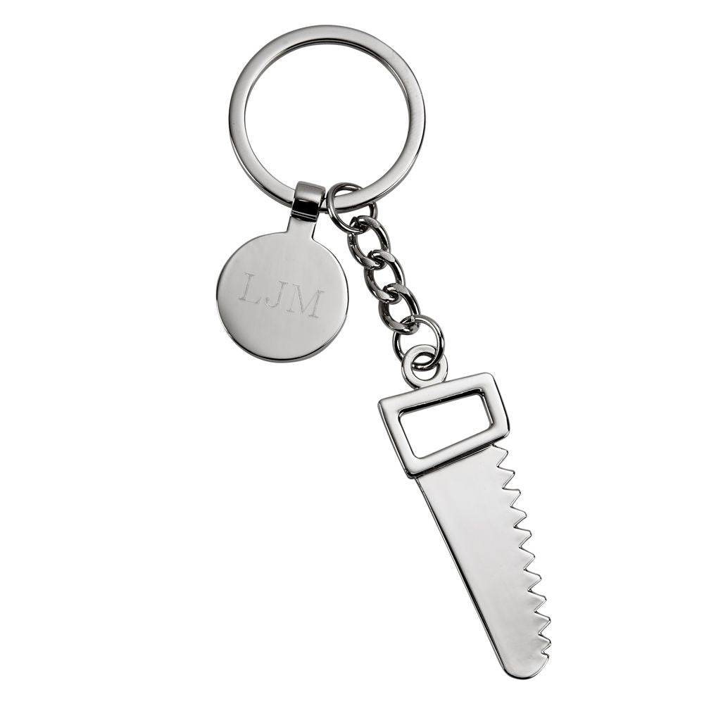 A polished nickelplated saw keychain with an engraving tag, elegantly displayed in a black gift box.