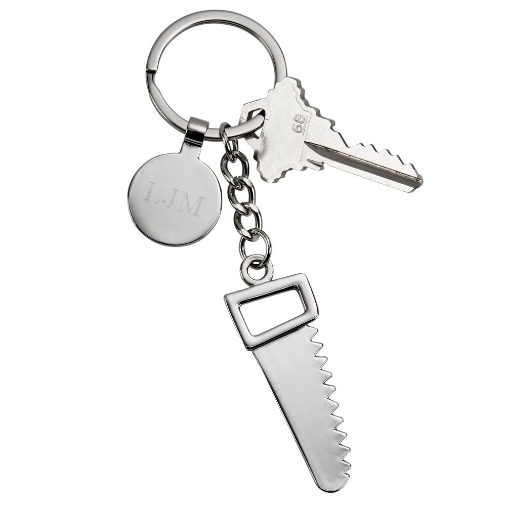 A polished nickelplated saw keychain with an engraving tag, elegantly displayed in a black gift box.