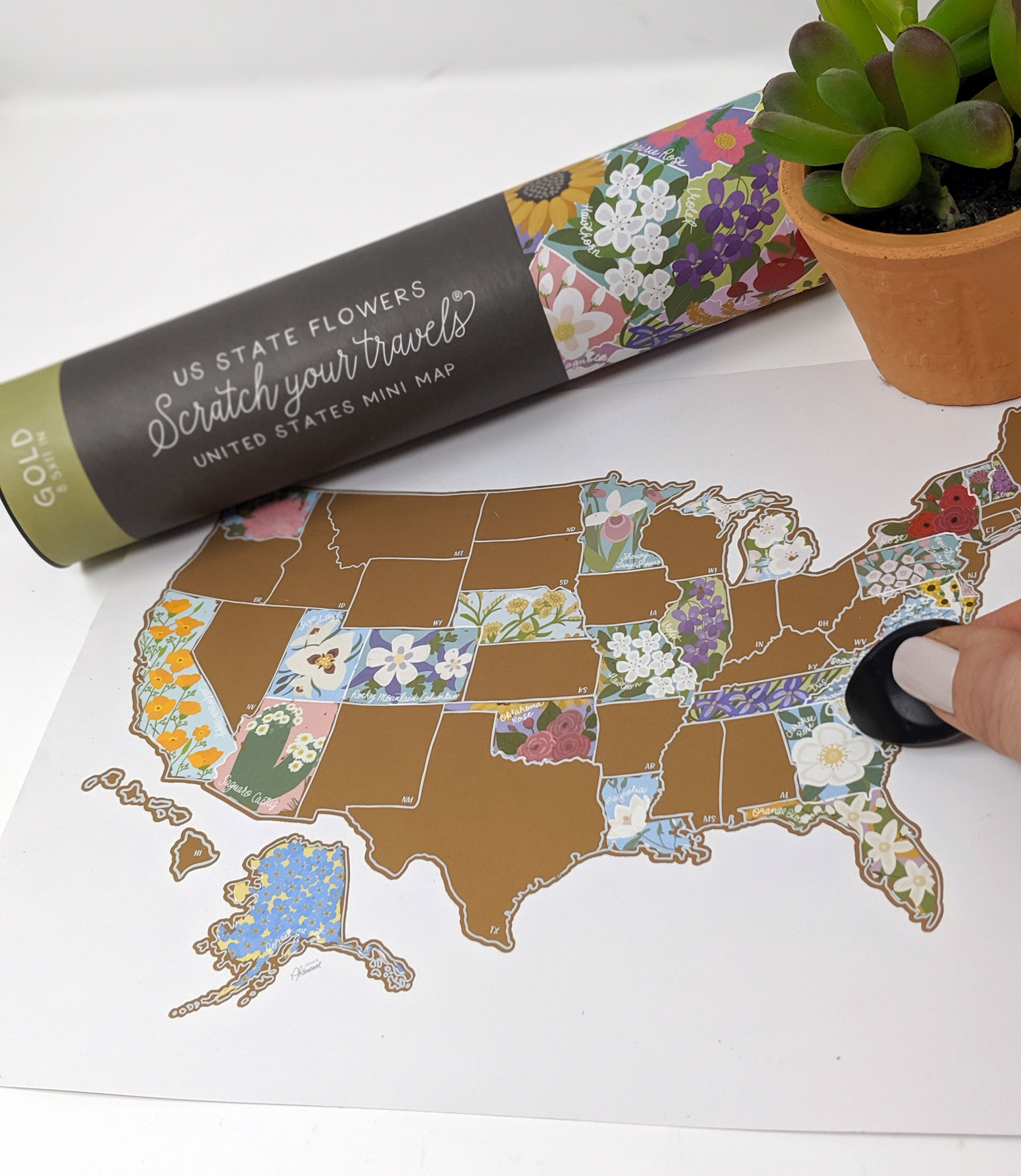 Scratch Your Travels® USA State Flowers Map with gold scratch-off finish, showcasing hand-drawn flowers for each state.