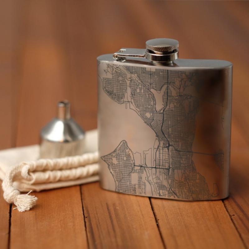 Custom engraved Seattle map hip flask with canvas bag and funnel, showcasing coordinates.