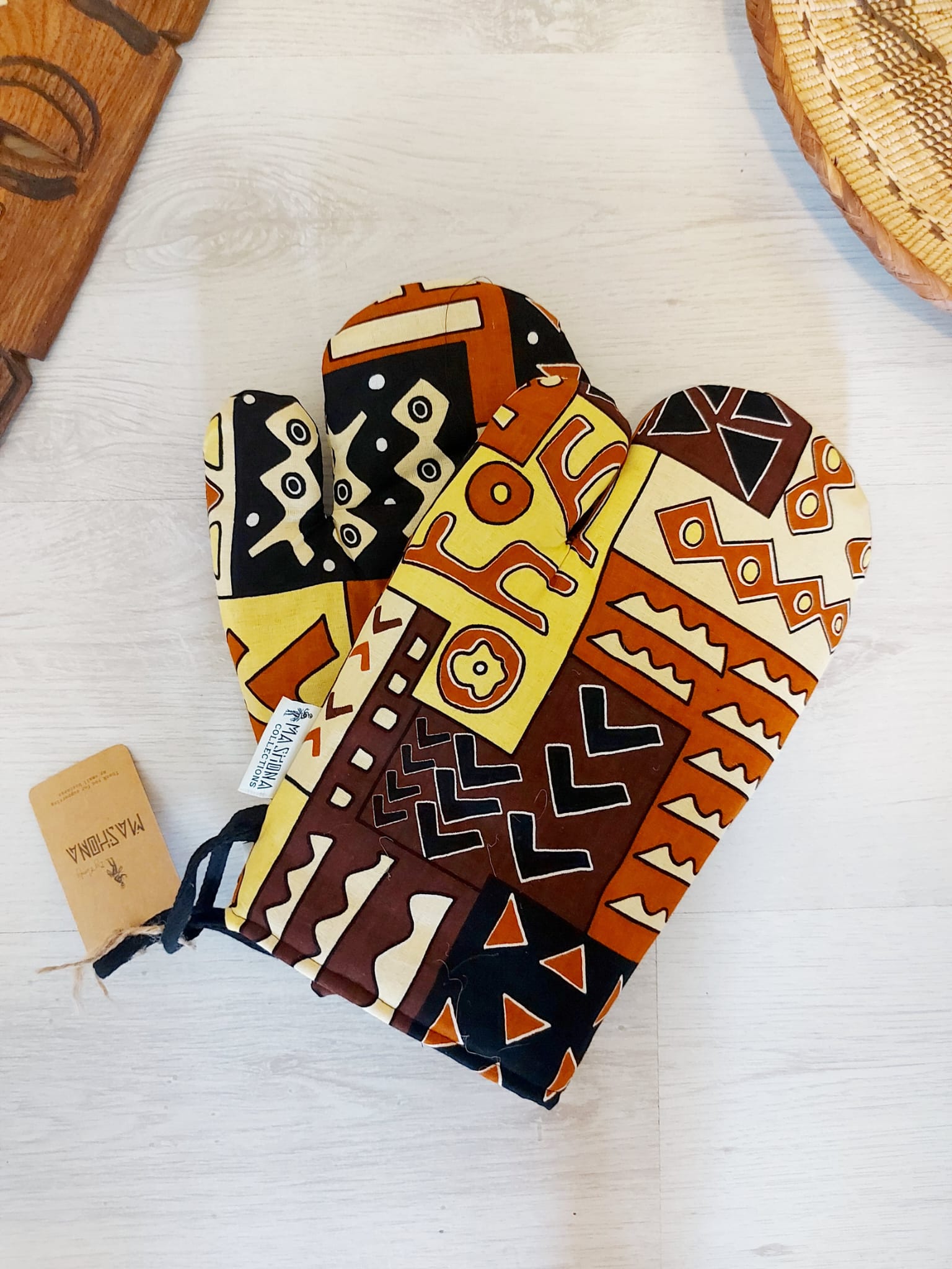 Set of 2 Handmade Mudcloth Oven Mitts featuring vibrant African prints, designed for heat resistance and convenience in the kitchen.