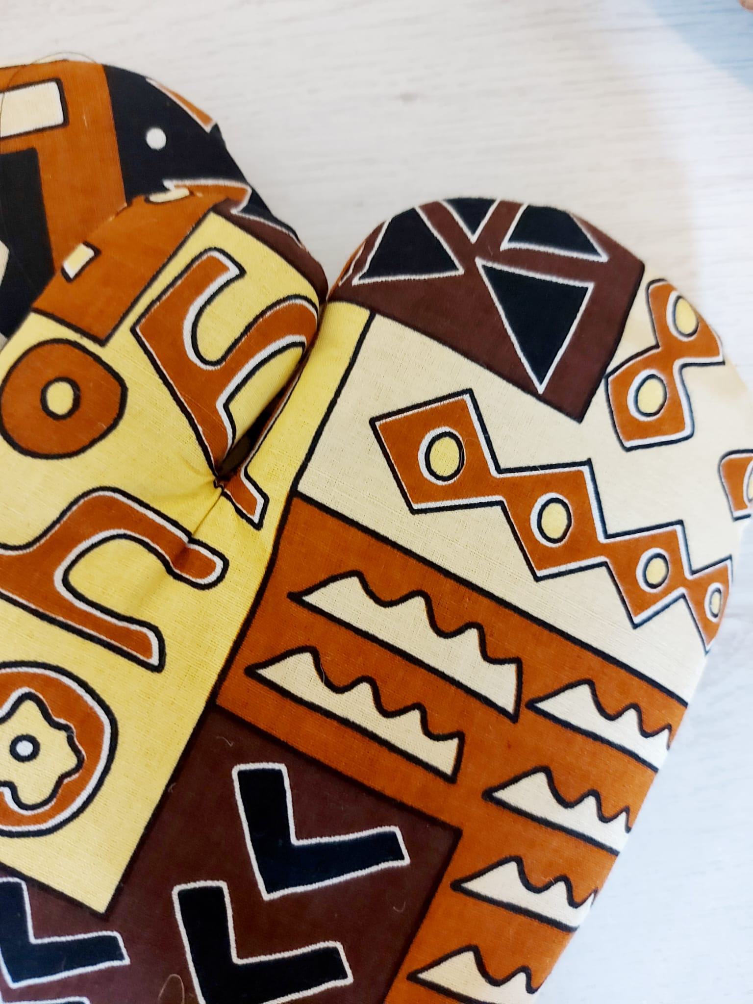 Set of 2 Handmade Mudcloth Oven Mitts featuring vibrant African prints, designed for heat resistance and convenience in the kitchen.