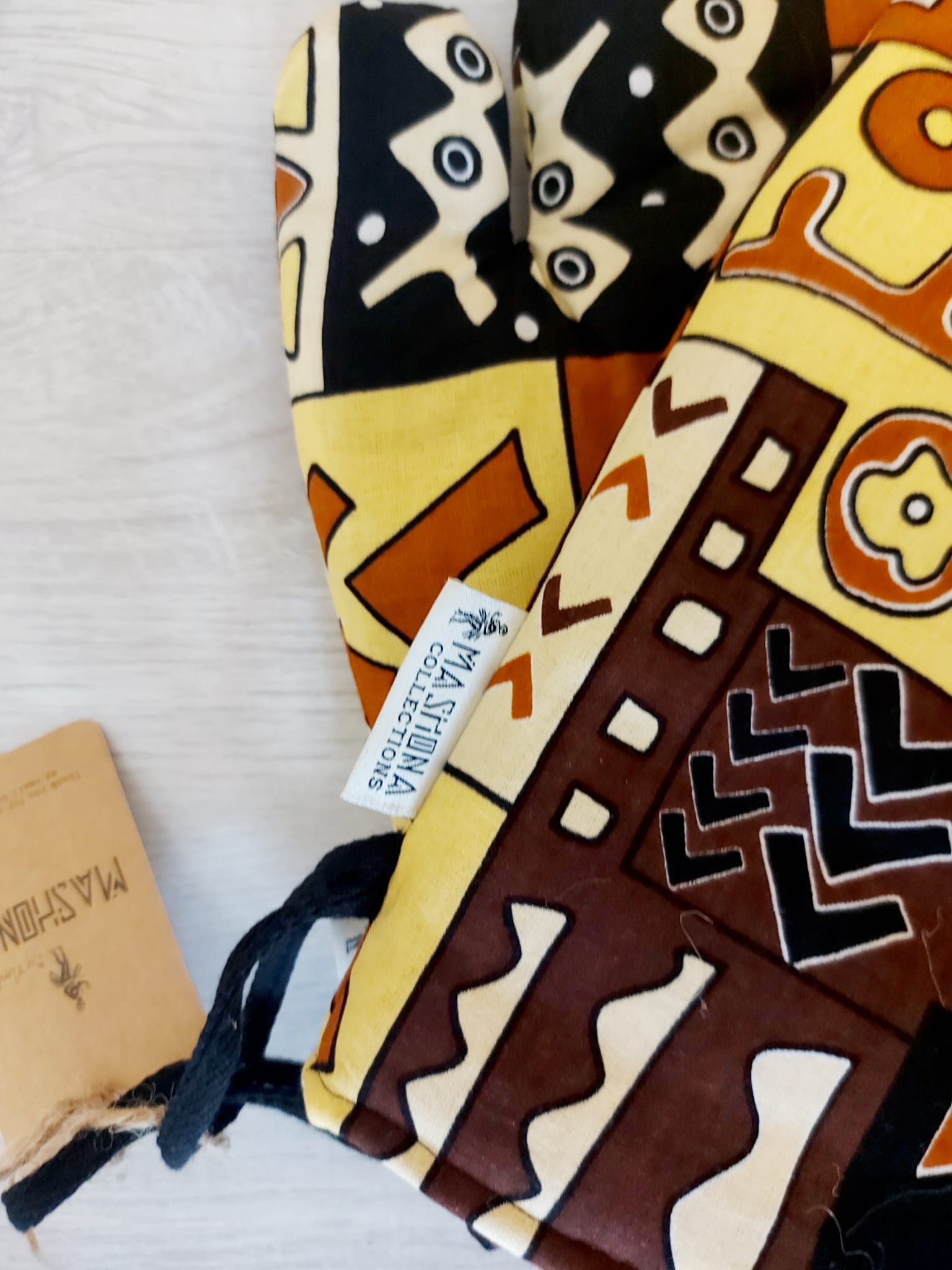 Set of 2 Handmade Mudcloth Oven Mitts featuring vibrant African prints, designed for heat resistance and convenience in the kitchen.