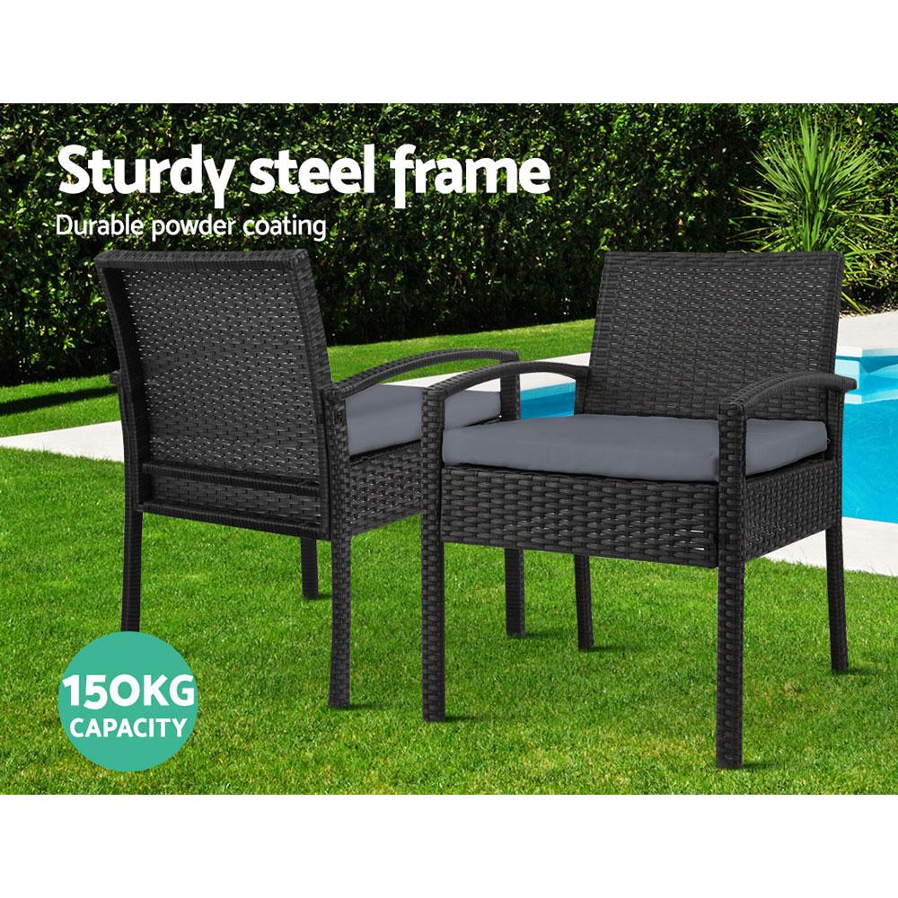 Set of 2 stylish outdoor dining chairs made of wicker with grey cushions, perfect for patio or garden use.