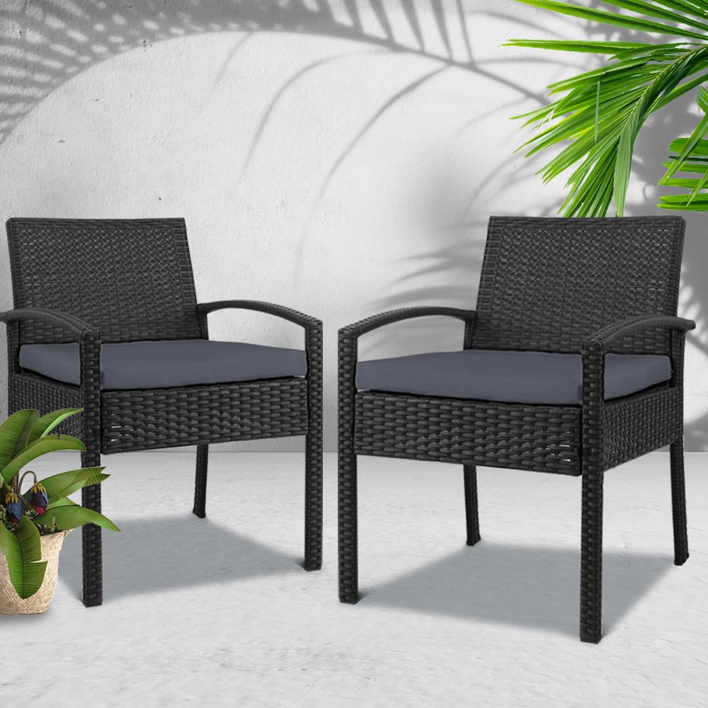 Set of 2 stylish outdoor dining chairs made of wicker with grey cushions, perfect for patio or garden use.