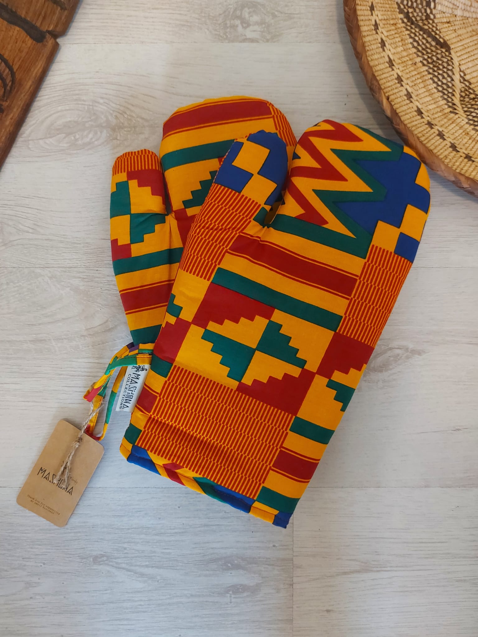 Set of 2 handmade oven gloves featuring vibrant Mudcloth Bogolan print, designed for heat resistance and comfort in the kitchen.