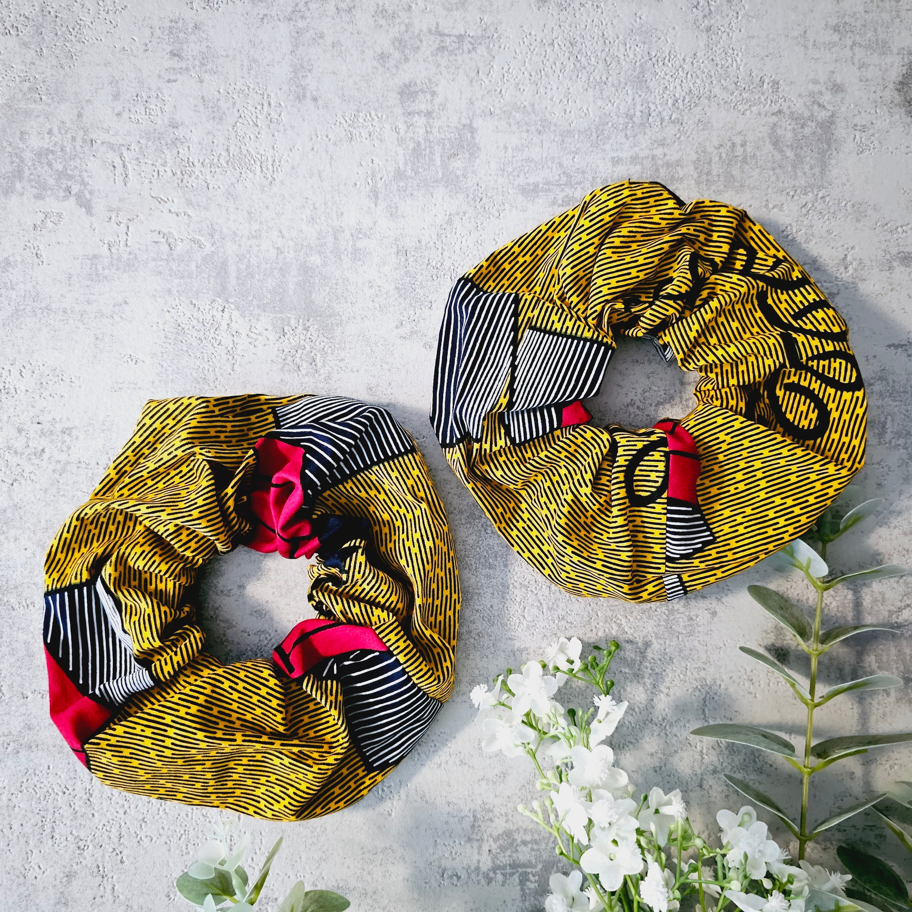 A vibrant set of 2 XL hair scrunchies in various colors, showcasing their soft fabric and durable design.