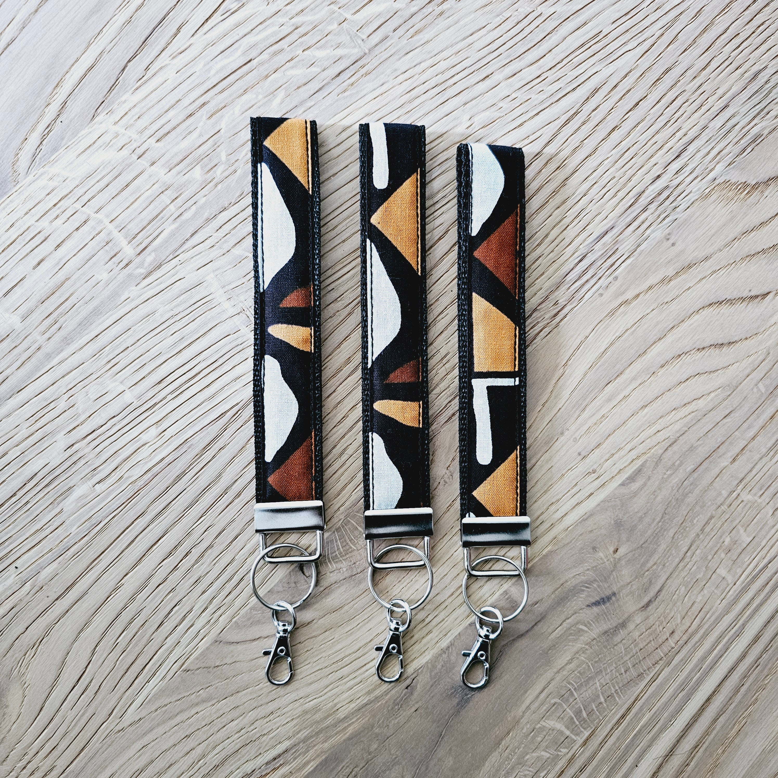 Set of 3 vibrant African print key fobs with wristlet design, showcasing unique patterns and vegan leather lining.