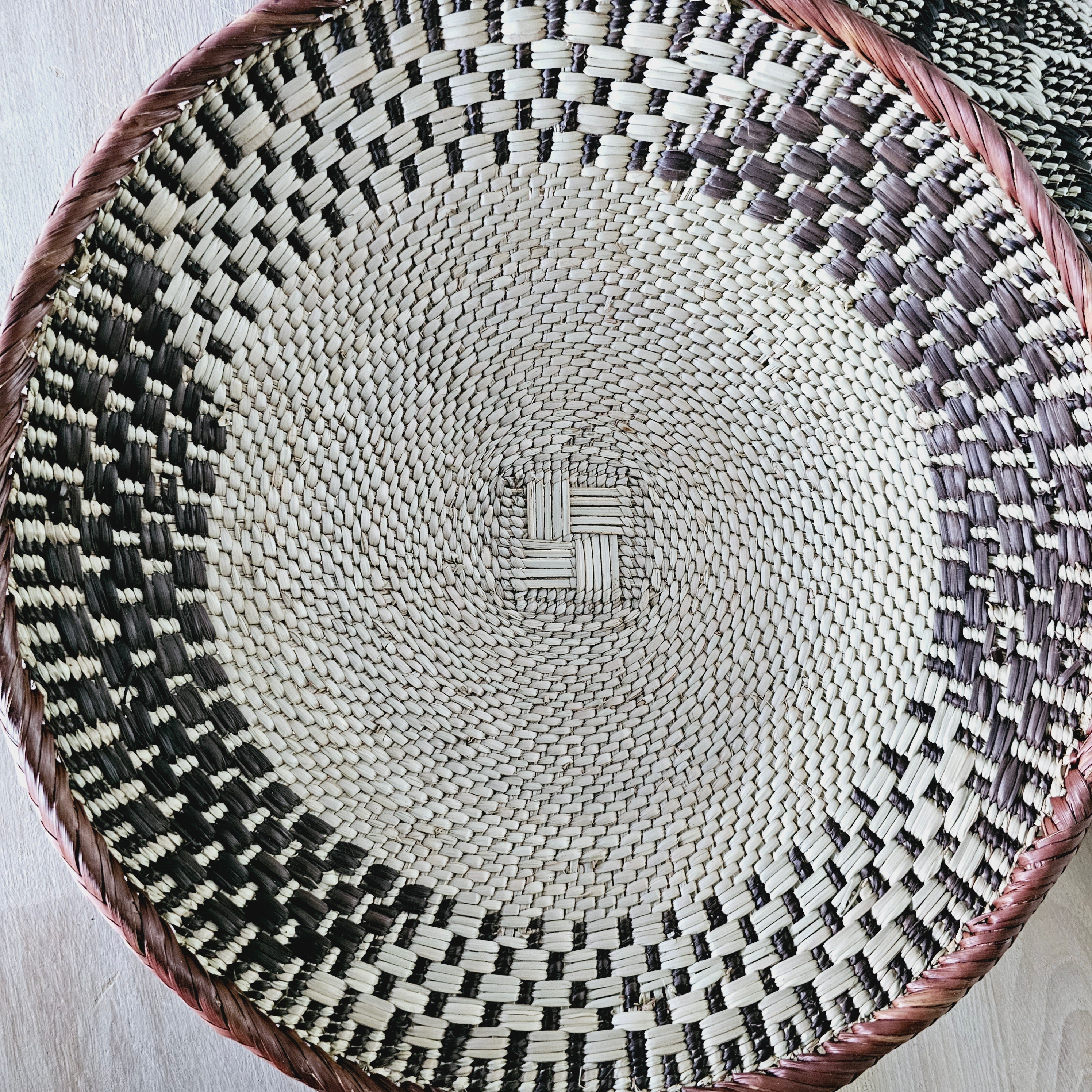 Set of 4 handmade African baskets from Zimbabwe, showcasing intricate patterns and natural materials, perfect for Boho wall decor.