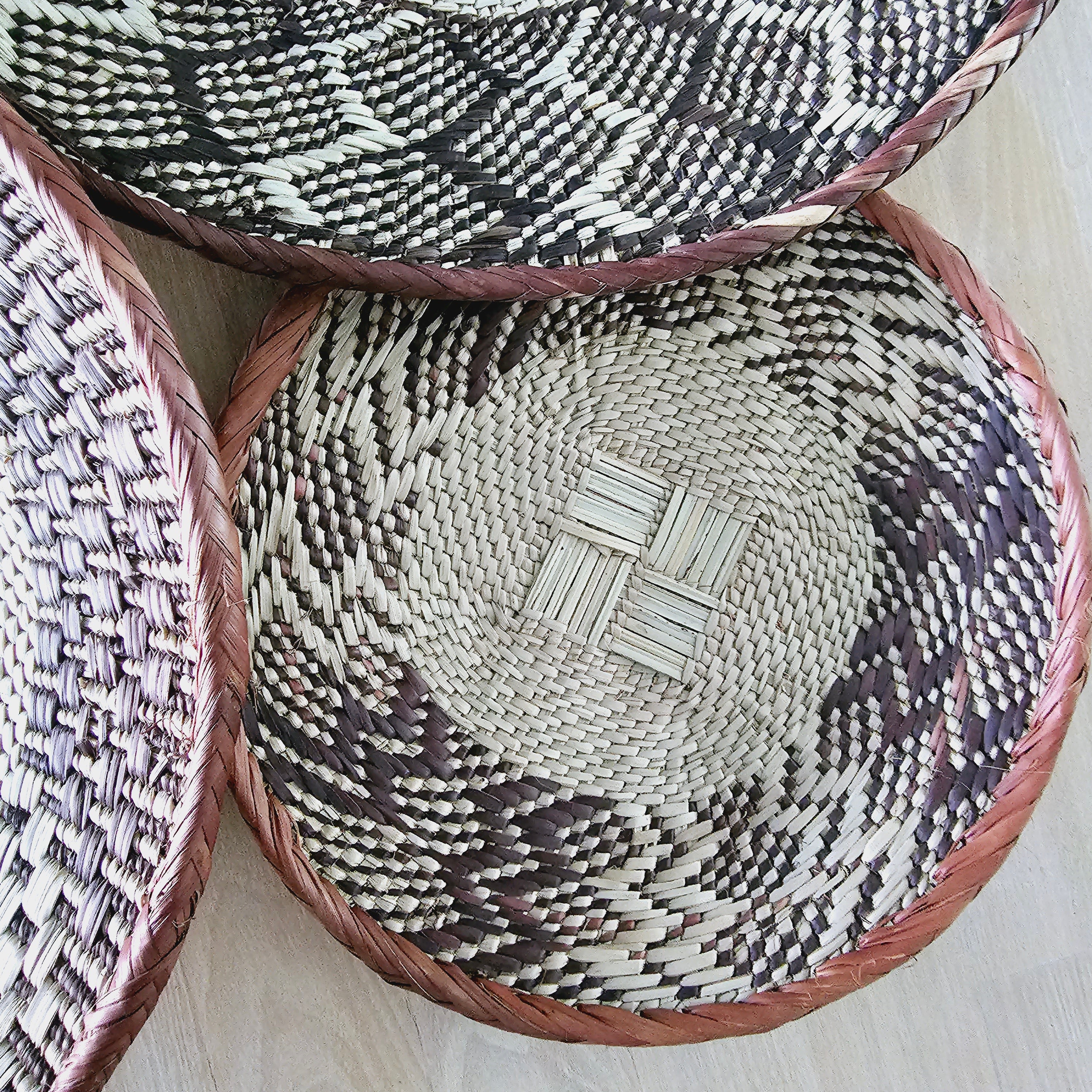 Set of 4 handmade African baskets from Zimbabwe, showcasing intricate patterns and natural materials, perfect for Boho wall decor.