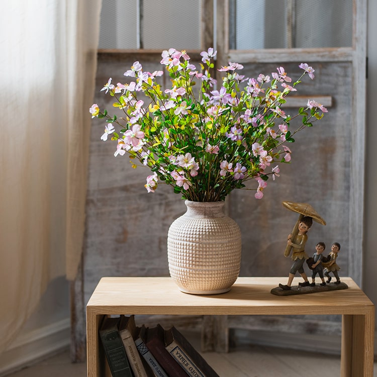 A 20-inch tall Silk Faux Gaura Flower Stem in pink, featuring realistic petals and dark green leaves, perfect for home decor.