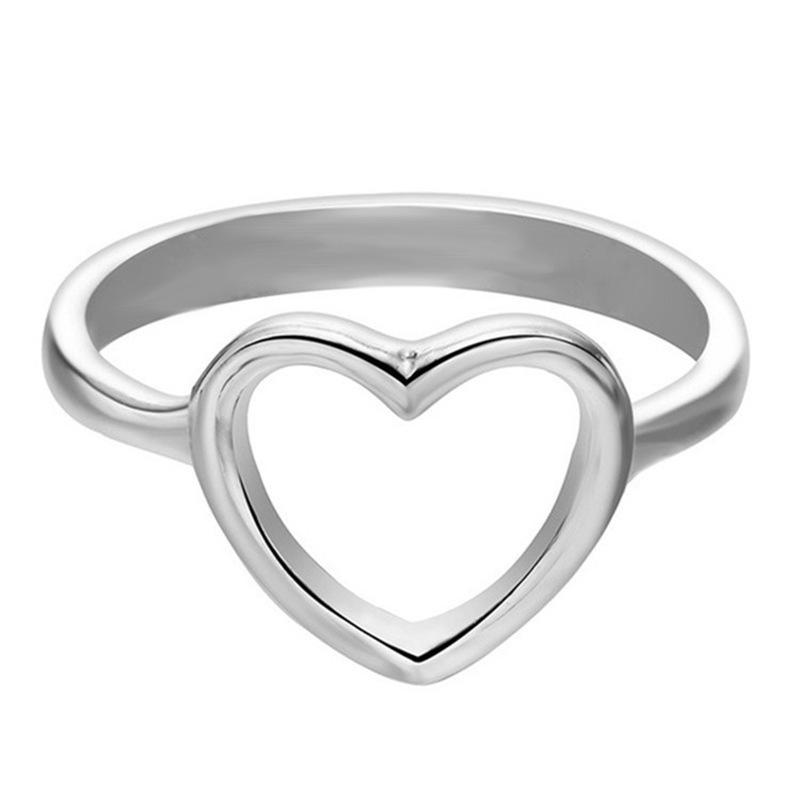 Simple Hollow Design Love Heart Ring for Women, showcasing a delicate heart pattern in brass, available in silver and gold colors.