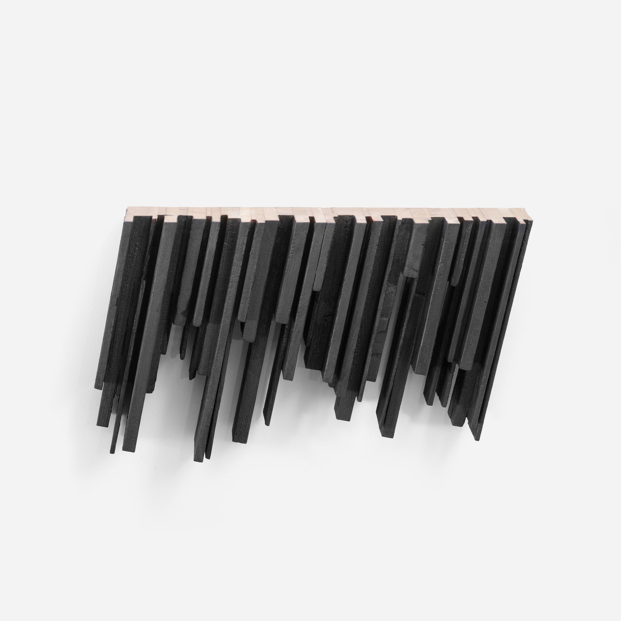 Skyline shelf made from recycled wood with a dynamic inverted design, showcasing torched black and natural finishes.