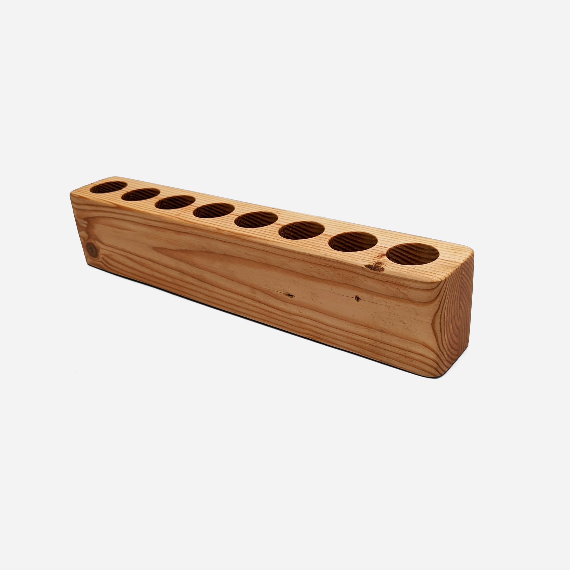 Slot cooking utensil holder made from Doug Fir wood, featuring a narrow design to save counter space and store up to eight utensils.