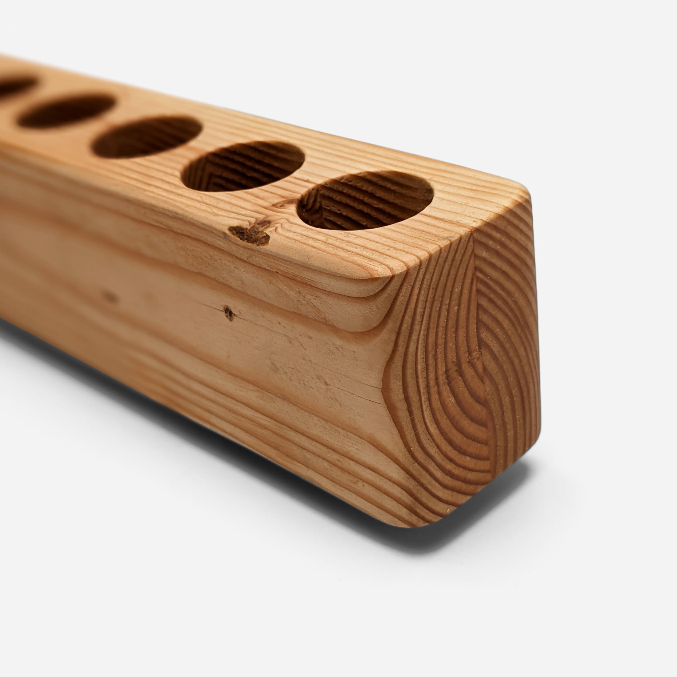 Slot cooking utensil holder made from Doug Fir wood, featuring a narrow design to save counter space and store up to eight utensils.