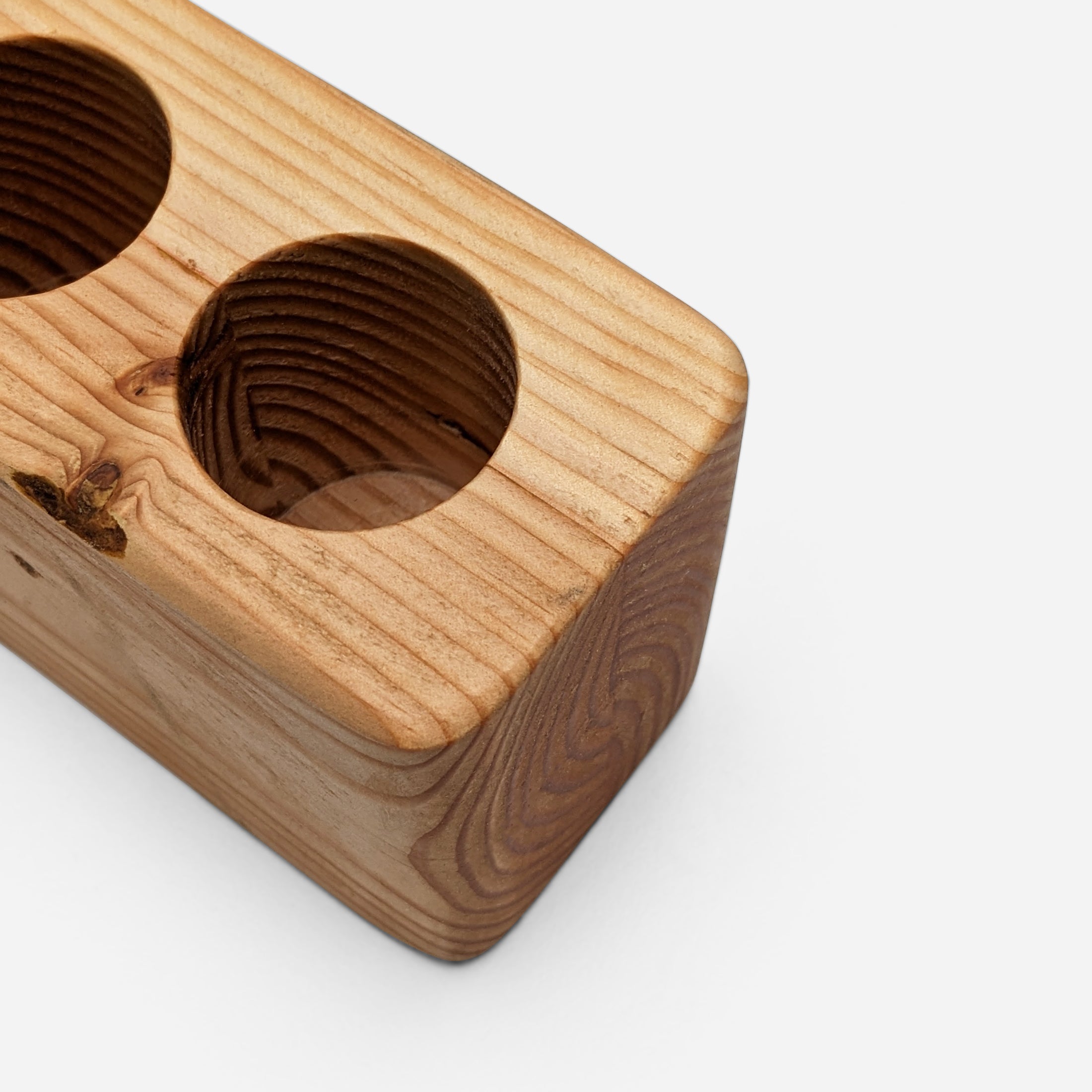 Slot cooking utensil holder made from Doug Fir wood, featuring a narrow design to save counter space and store up to eight utensils.