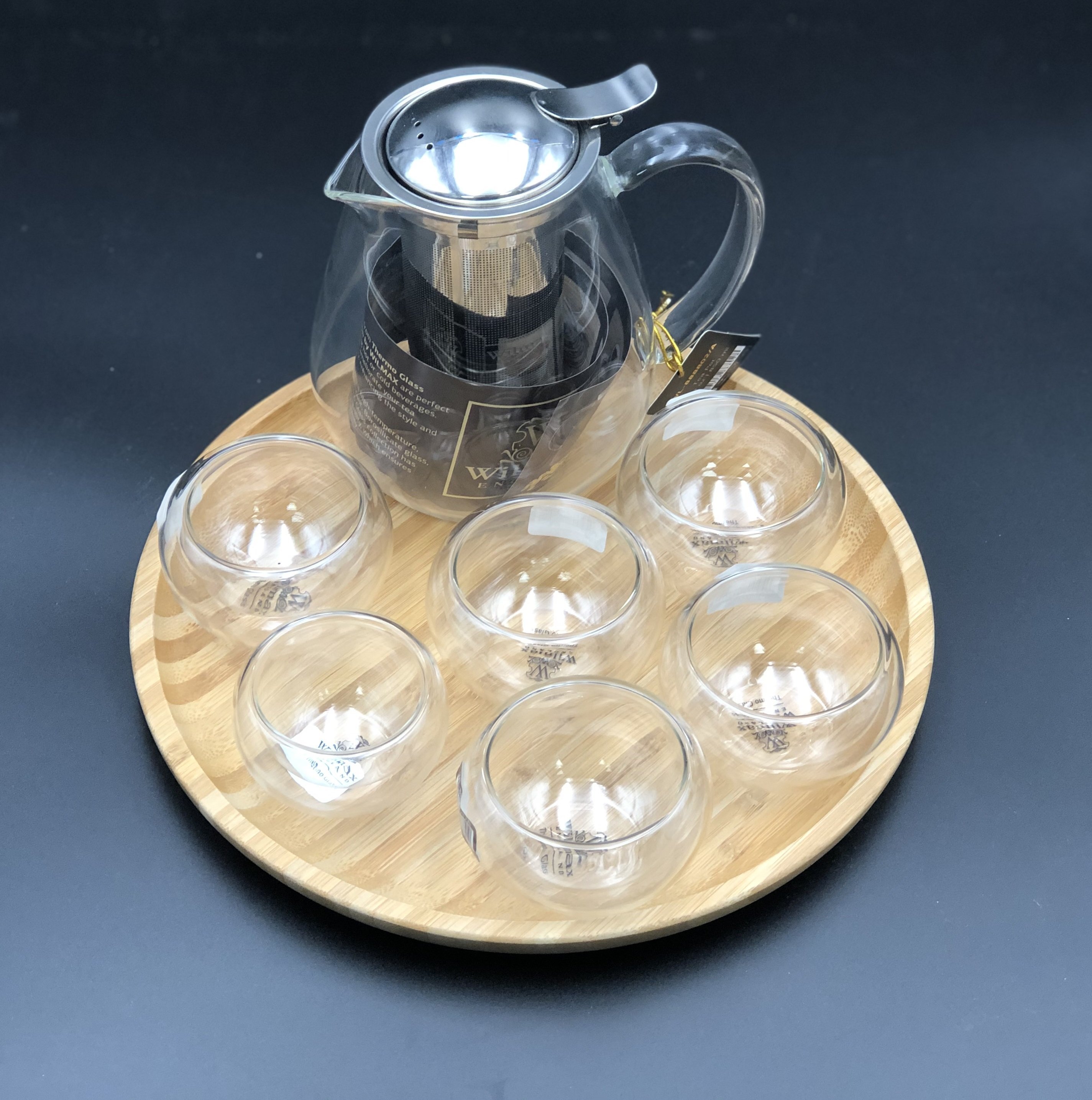 Small Asian tea thermo set featuring a teapot, bamboo platter, and six double-walled bowls for serving tea.