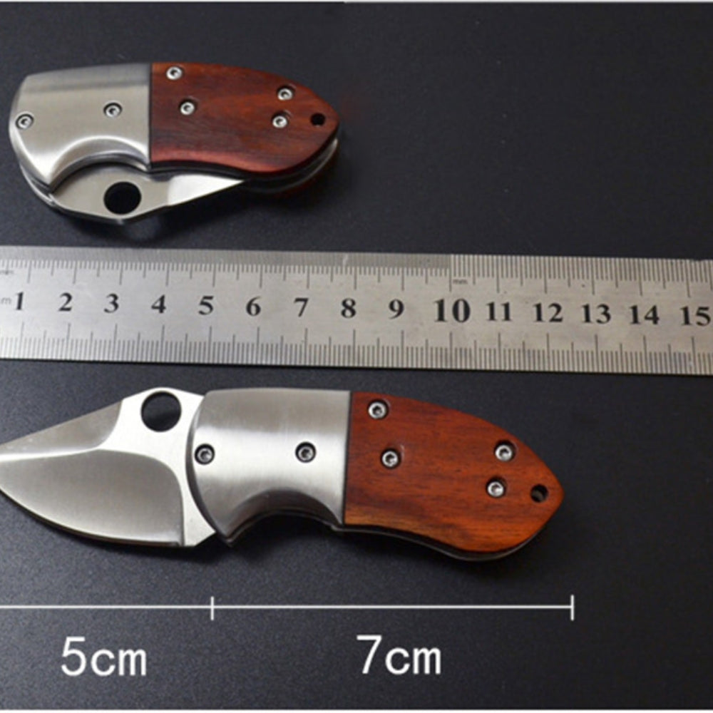 Small Mini Stainless Steel Folding Pocket Knife with shadow wood handle and keychain attachment, ideal for outdoor use.