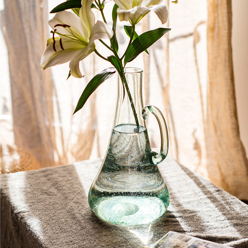 A 13-inch tall bubble glass kettle vase with a small opening, featuring a clear and light green color, perfect for floral arrangements.