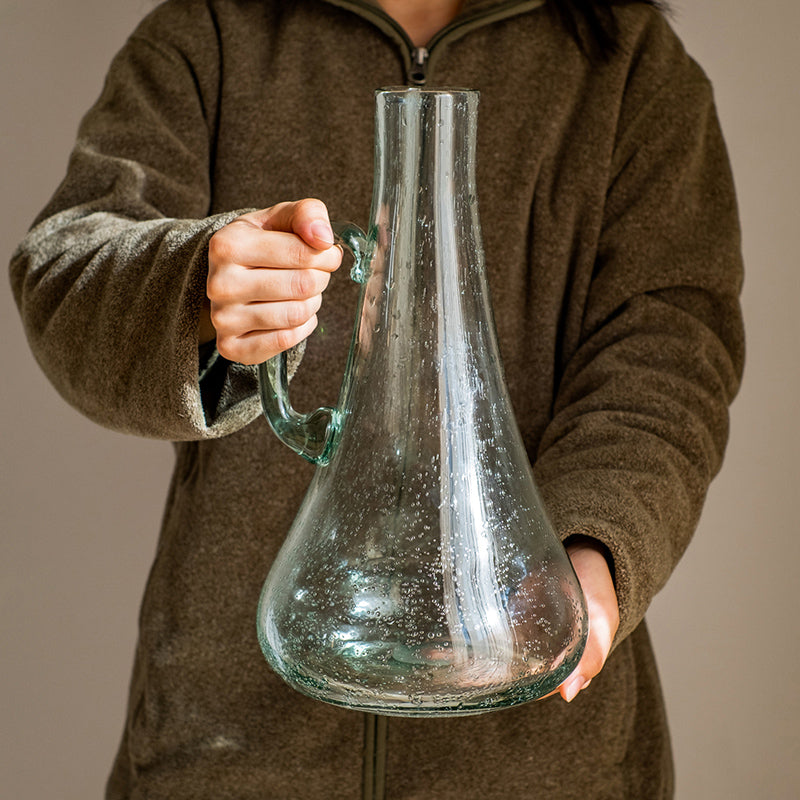 A 13-inch tall bubble glass kettle vase with a small opening, featuring a clear and light green color, perfect for floral arrangements.