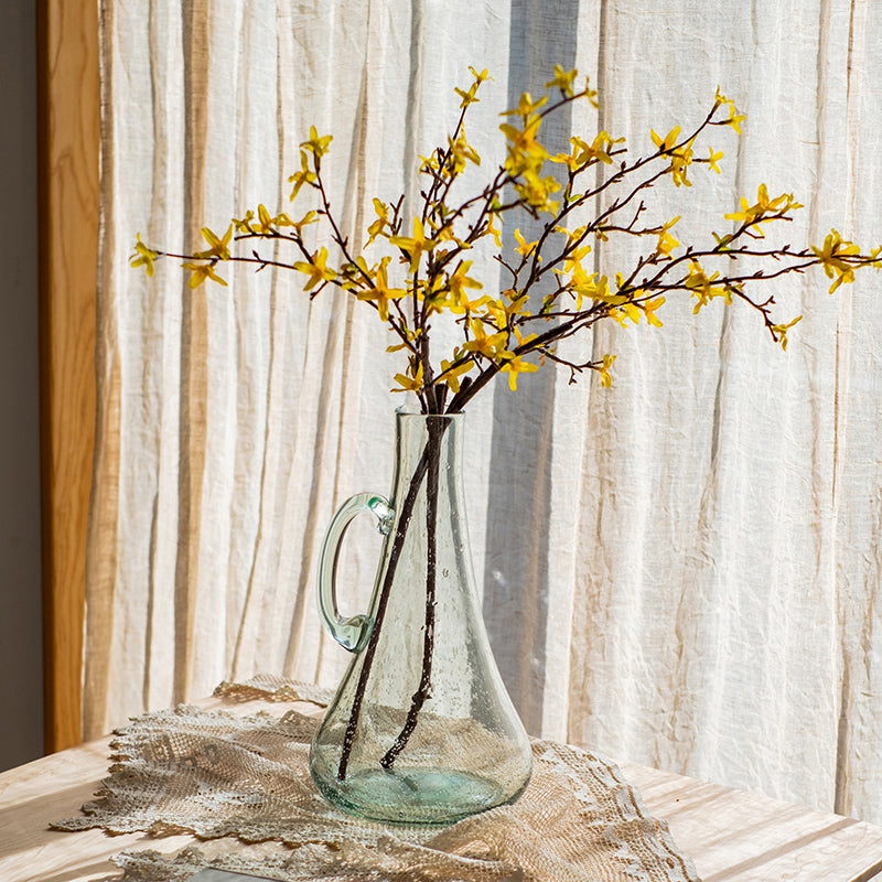 A 13-inch tall bubble glass kettle vase with a small opening, featuring a clear and light green color, perfect for floral arrangements.