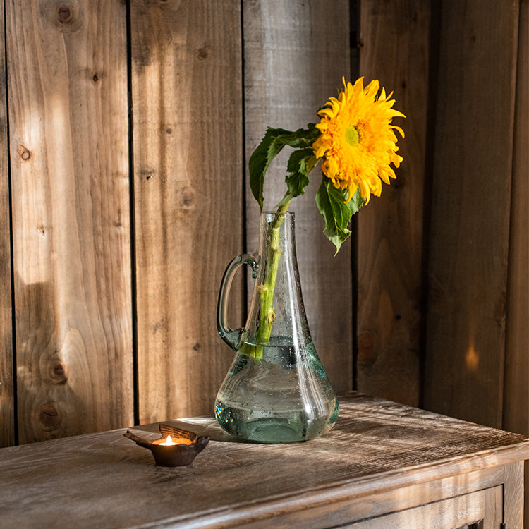 A 13-inch tall bubble glass kettle vase with a small opening, featuring a clear and light green color, perfect for floral arrangements.