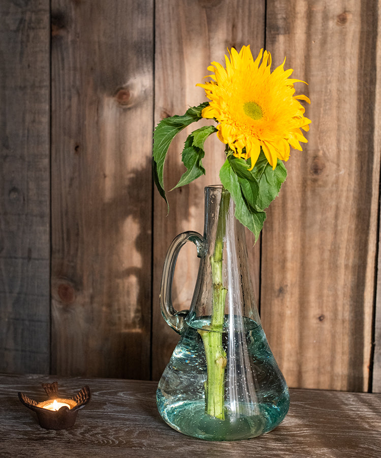 A 13-inch tall bubble glass kettle vase with a small opening, featuring a clear and light green color, perfect for floral arrangements.