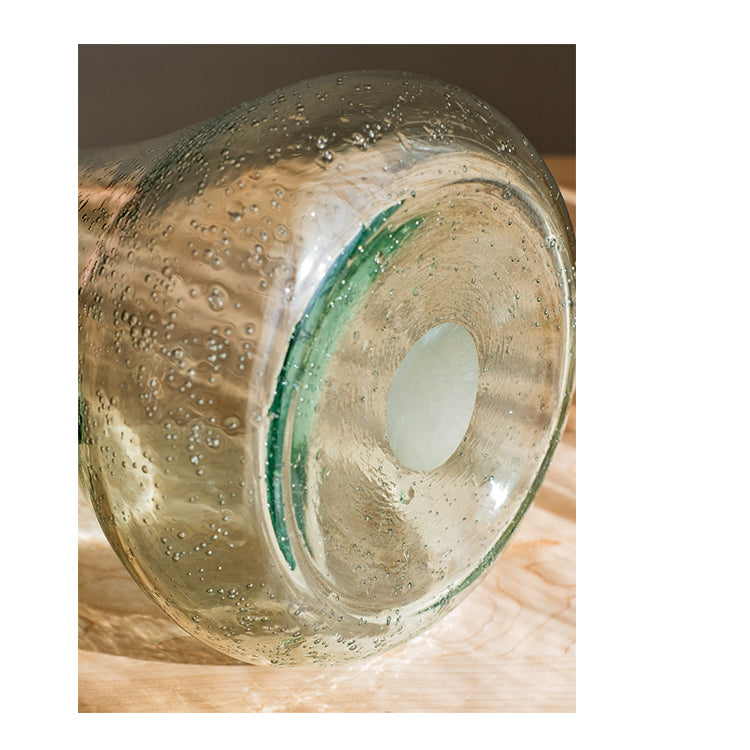 A 13-inch tall bubble glass kettle vase with a small opening, featuring a clear and light green color, perfect for floral arrangements.