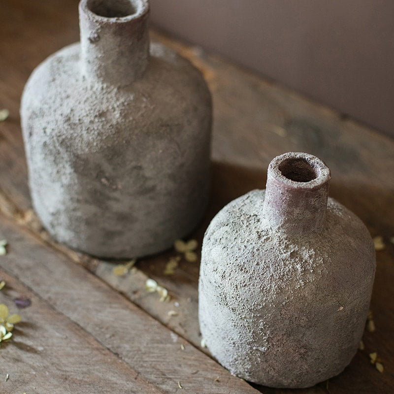 A handmade small opening stoneware terracotta vase in gray and white, showcasing its unique shape and artisanal quality.