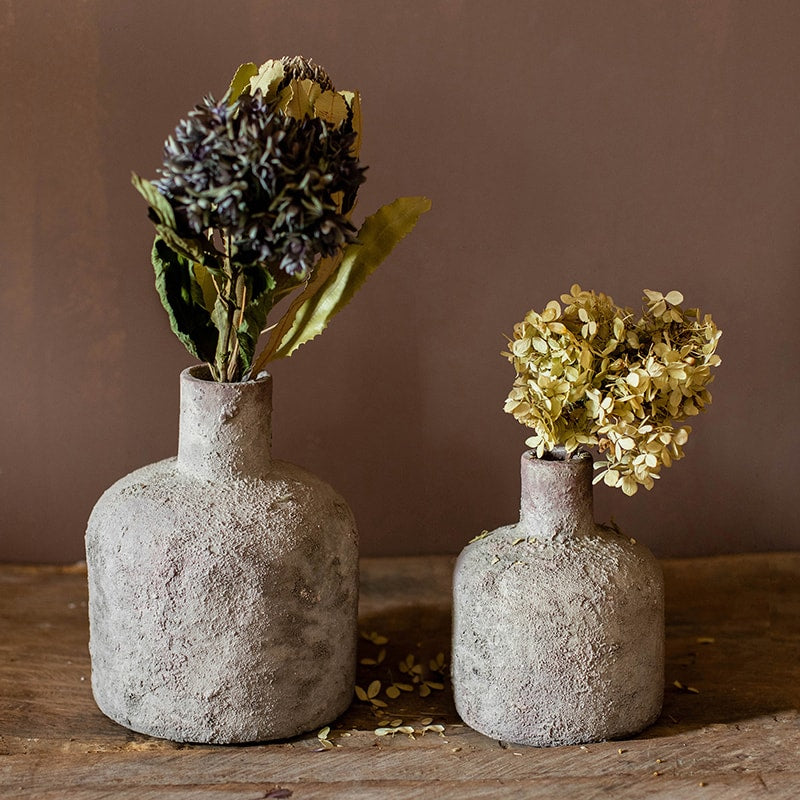 A handmade small opening stoneware terracotta vase in gray and white, showcasing its unique shape and artisanal quality.