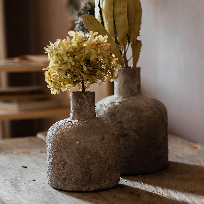 A handmade small opening stoneware terracotta vase in gray and white, showcasing its unique shape and artisanal quality.