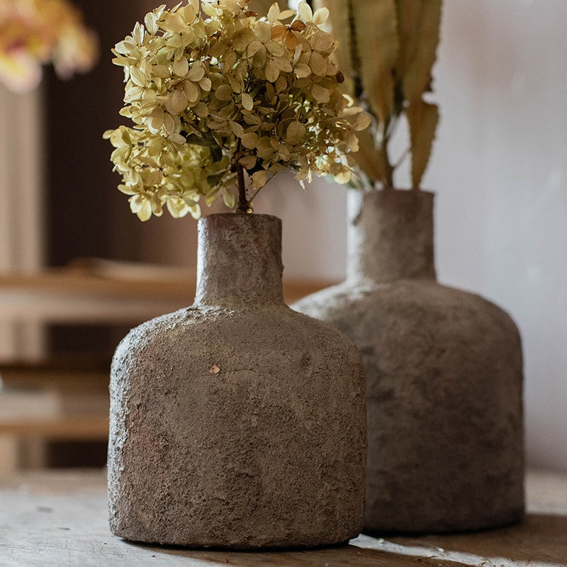 A handmade small opening stoneware terracotta vase in gray and white, showcasing its unique shape and artisanal quality.