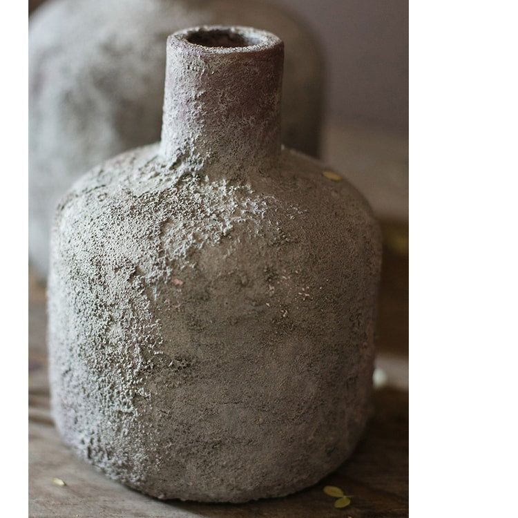 A handmade small opening stoneware terracotta vase in gray and white, showcasing its unique shape and artisanal quality.