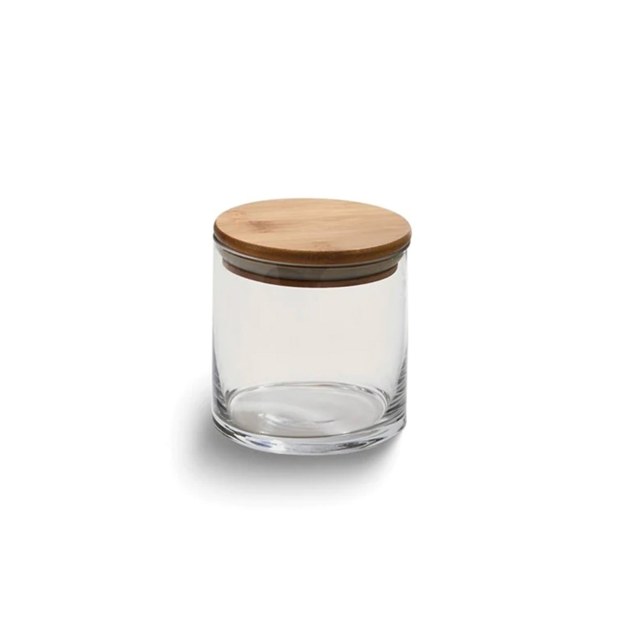 Small round glass storage container with a bamboo lid, showcasing its sleek design and rubber gasket for a tight seal.