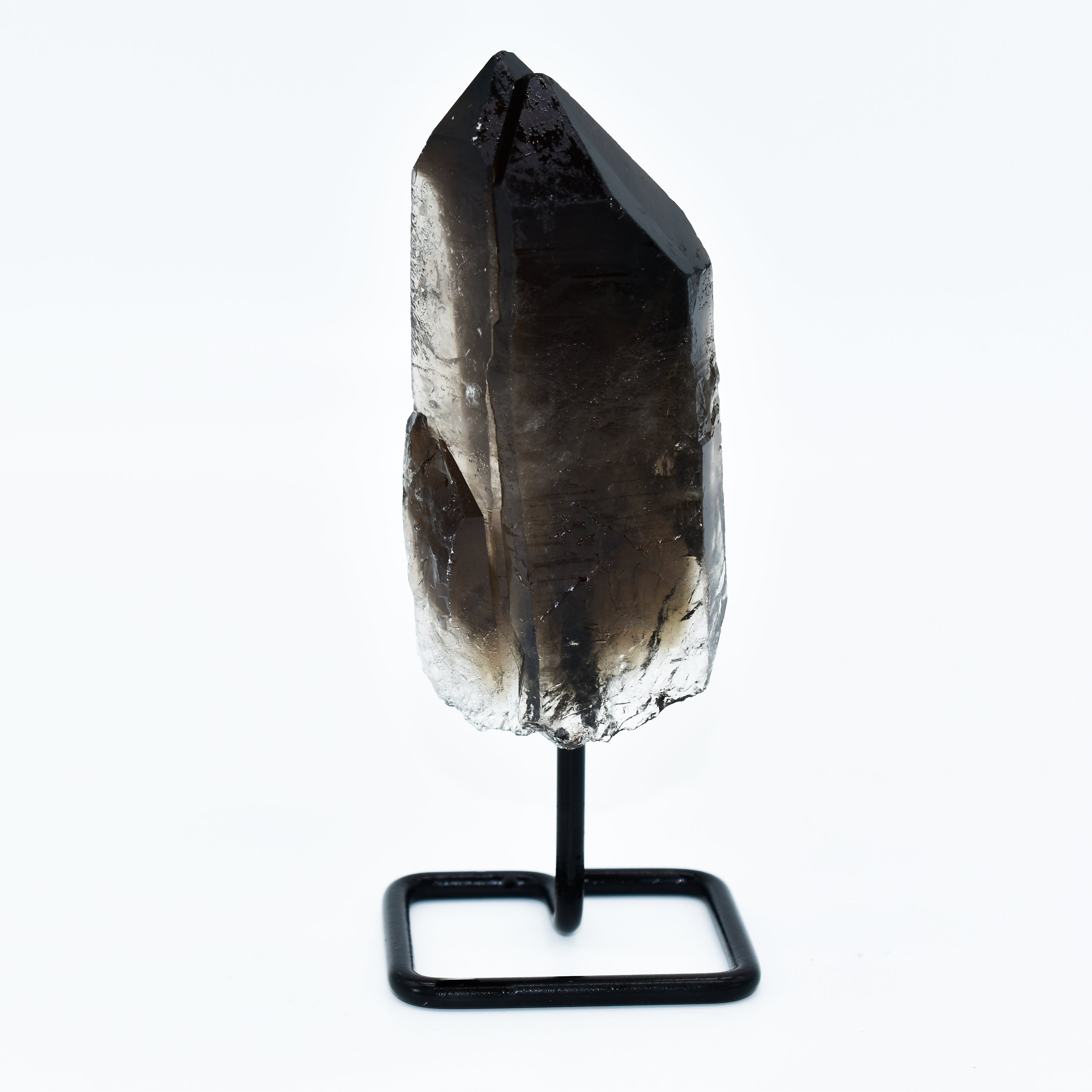 A unique Smokey Quartz point mounted on a sleek metal base, showcasing its natural beauty and distinct patterns.