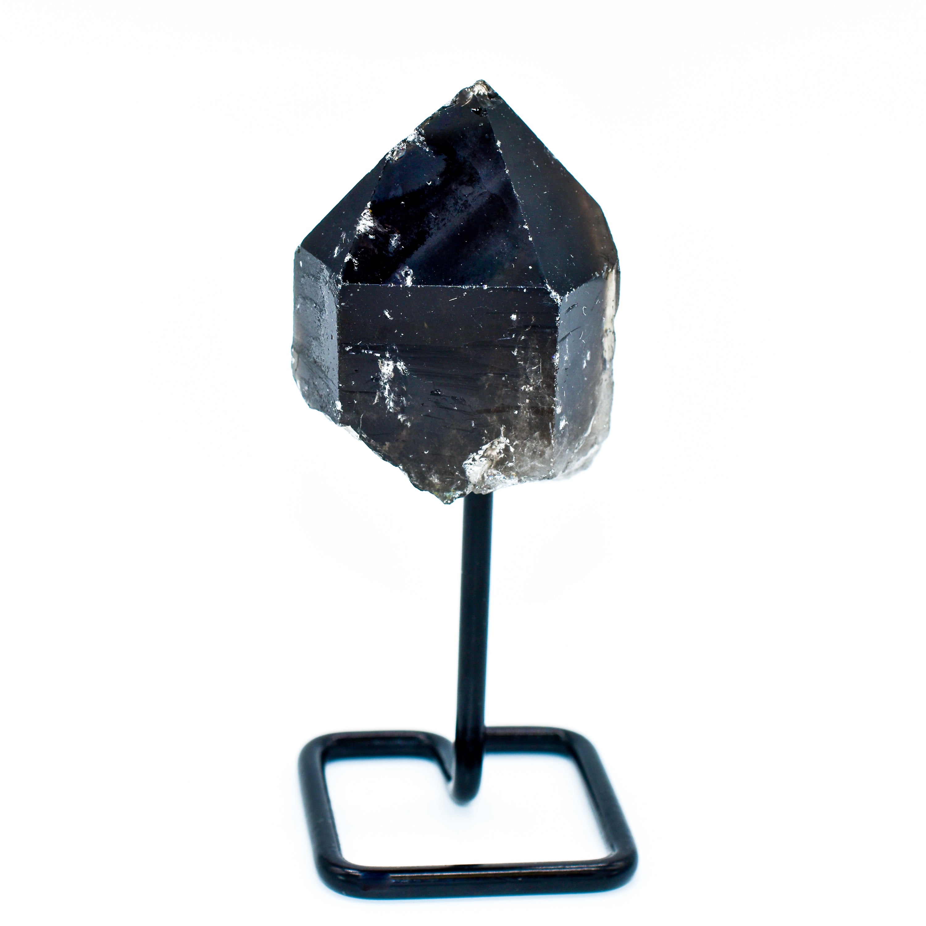 A unique Smokey Quartz point mounted on a sleek metal base, showcasing its natural beauty and distinct patterns.