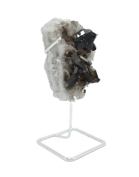 A beautiful smoky quartz cluster displayed on a gold wire stand, showcasing its natural formations and colors.