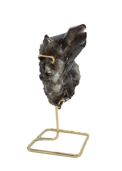 A beautiful smoky quartz cluster displayed on a gold wire stand, showcasing its natural formations and colors.