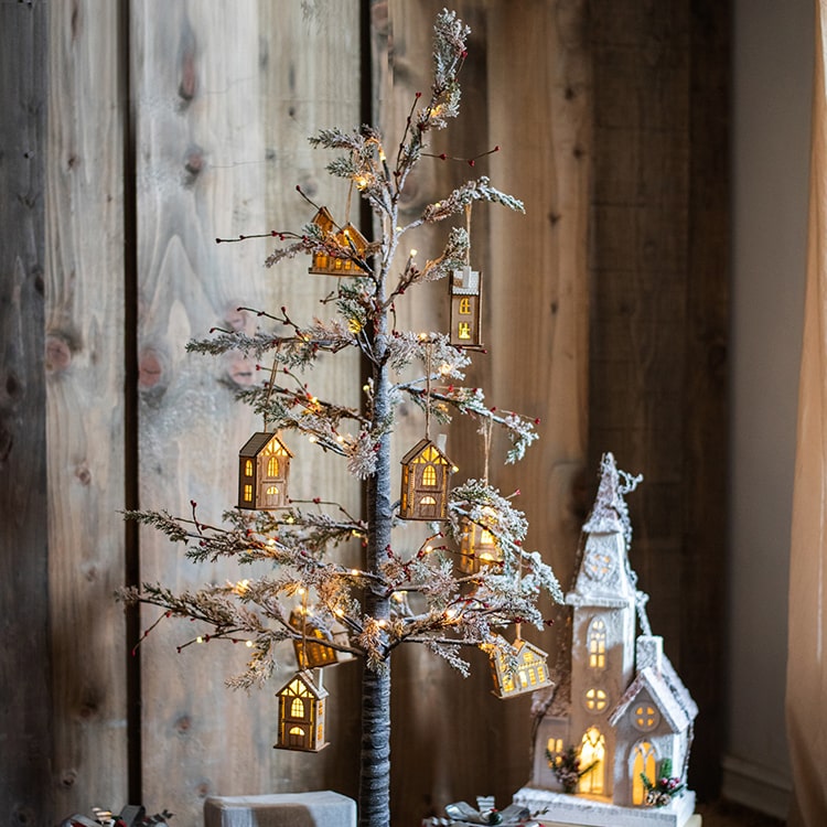 A beautifully decorated Snow Flocked Lighted Christmas Tree with red berry branches, standing 49.6 inches tall, showcasing a wintery aesthetic.