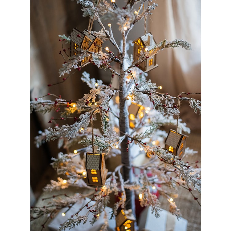 A beautifully decorated Snow Flocked Lighted Christmas Tree with red berry branches, standing 49.6 inches tall, showcasing a wintery aesthetic.