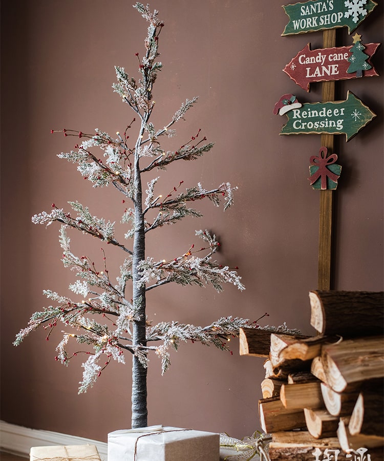 A beautifully decorated Snow Flocked Lighted Christmas Tree with red berry branches, standing 49.6 inches tall, showcasing a wintery aesthetic.