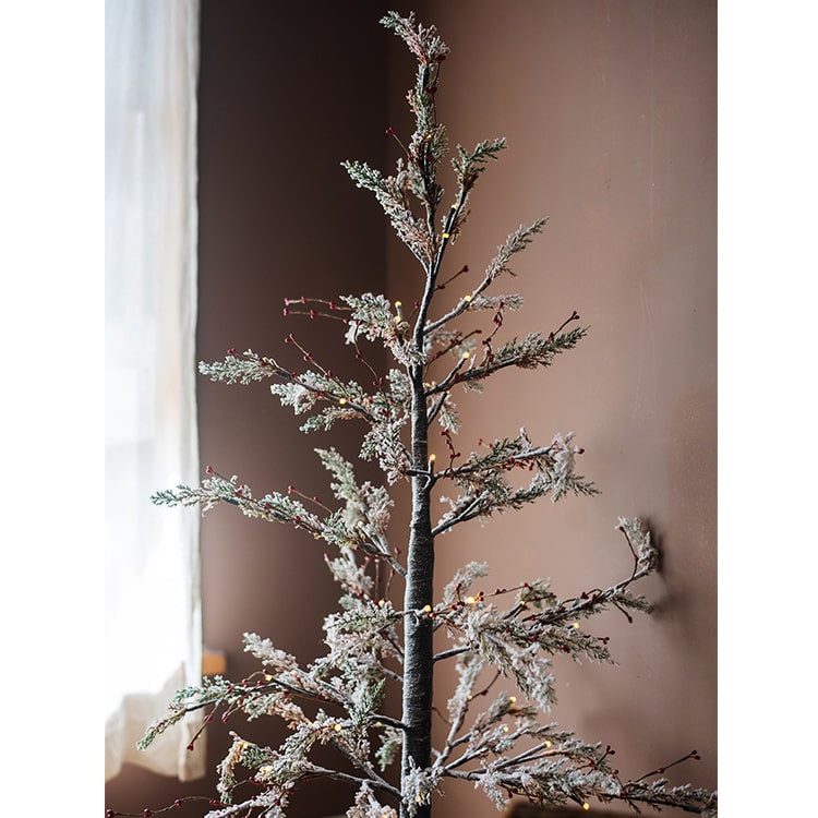 A beautifully decorated Snow Flocked Lighted Christmas Tree with red berry branches, standing 49.6 inches tall, showcasing a wintery aesthetic.